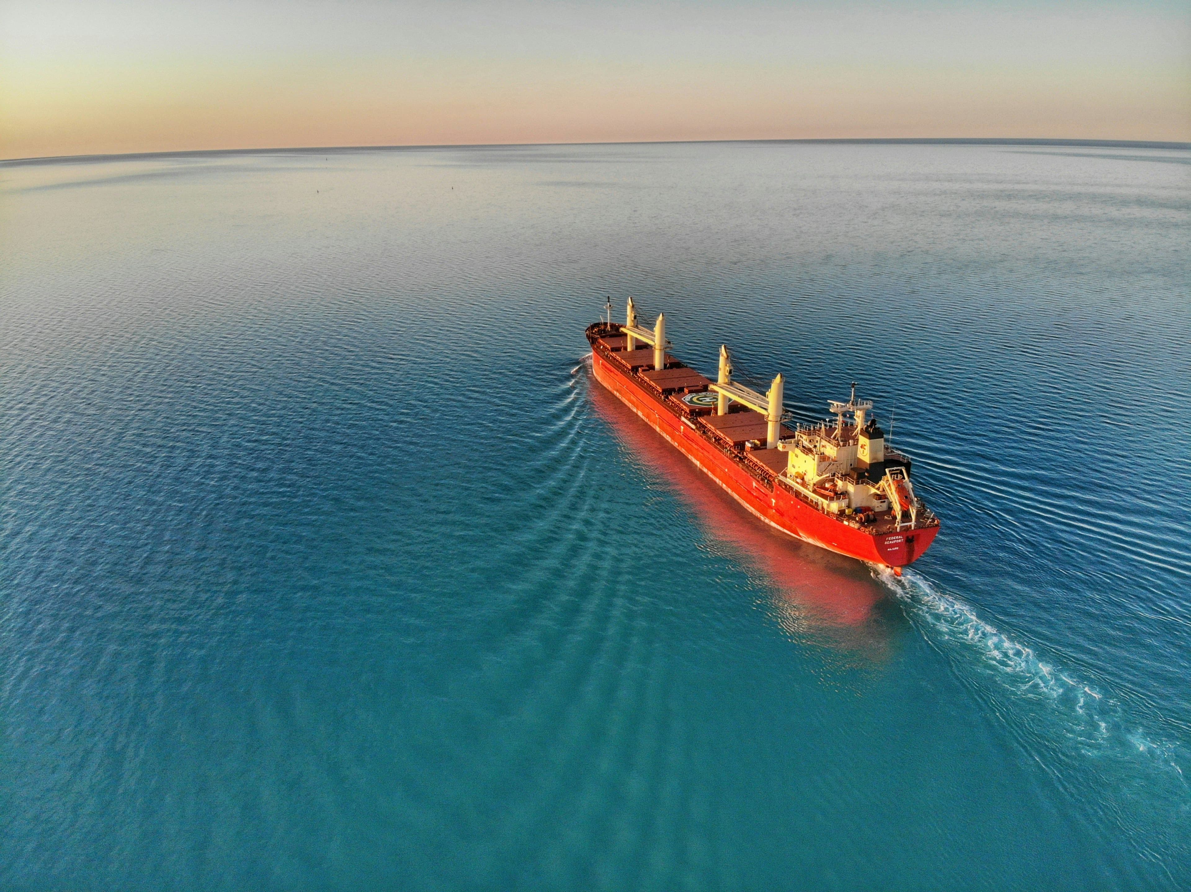 A ship going out to sea during sunset